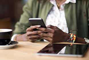 Woman holding phone checking bank balance.