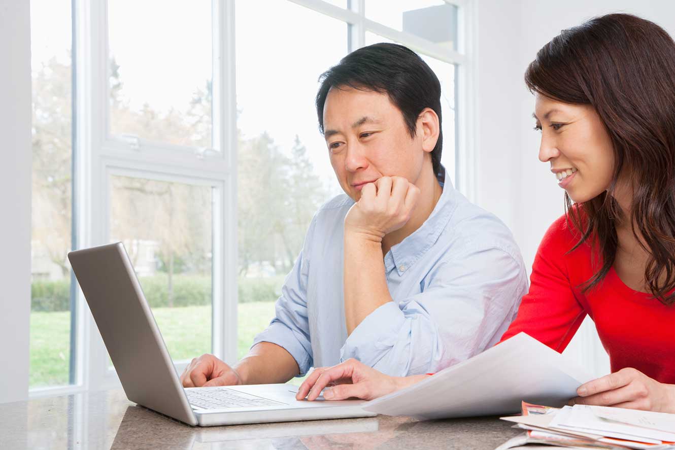 Couple working on computer.