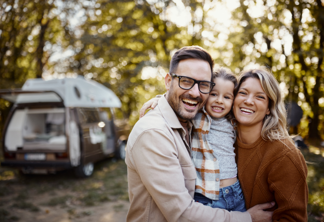 parents and child camping in a forest