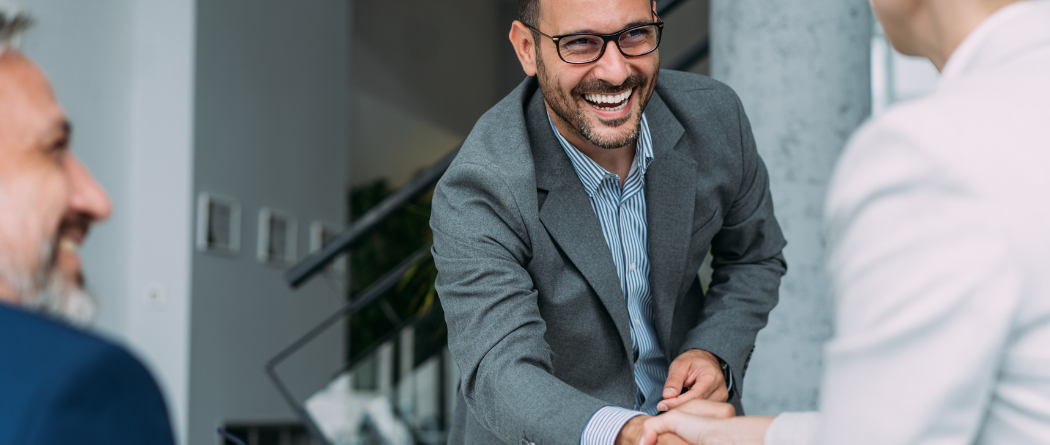 man giving a handshake in an office
