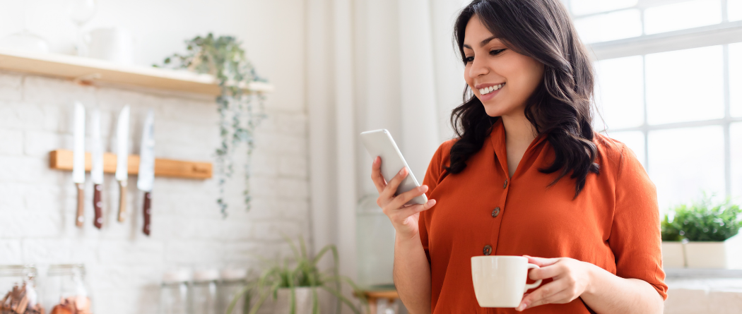 woman in kitchen with phone