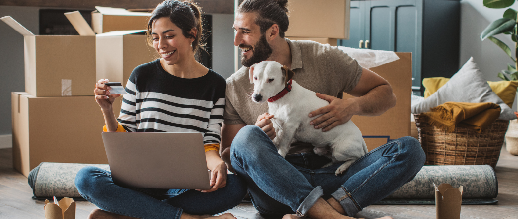 couple with dog in their new home