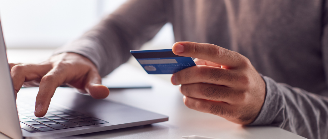 man using debit card to pay online