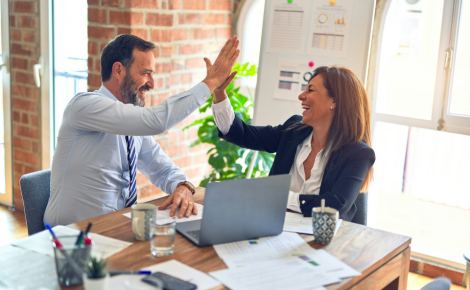 two coworkers high-fiving